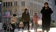 People wearing protective masks walk in a shopping district as China returns to work despite continuing coronavirus disease (COVID-19) outbreaks in Shanghai, China, January 3, 2023. (REUTERS/Aly Song)