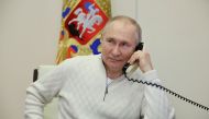 Russian President Vladimir Putin speaks on the phone with David Shmelev from Stavropol Region, a 7-year-old participant of a New Year's and Christmas charity event, at the Novo-Ogaryovo state residence outside Moscow, Russia, January 5, 2023. (Sputnik/Mikhail Klimentyev/Kremlin via REUTERS)