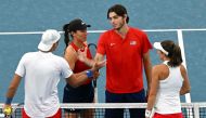 Taylor Fritz (second right) and Jessica Pegula (second left) of the US shake hands with Poland's Alicja Rosolska and Lukasz Kubot (left) after winning in the mixed doubles semi-final match at the United Cup tennis tournament in Sydney on January 7, 2023. (Photo by Saeed KHAN / AFP)