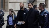 Andrew Tate and his brother Tristan are escorted by police officers outside the headquarters of the Bucharest Court of Appeal, in Bucharest, Romania, on January 10, 2023. Inquam Photos/Octav Ganea via REUTERS
