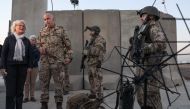 This file photo taken on January 9, 2022 shows German Defence Minister Christine Lambrecht talking to soldiers as she visited German armed forces in Arbil, the capital of the autonomous Kurdish region in northern Iraq.  (Photo by SAFIN HAMED / AFP)