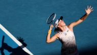 Poland's Iga Swiatek serves against Spain's Cristina Bucsa during their women's singles match on day five of the Australian Open tennis tournament in Melbourne on January 20, 2023. (Photo by Martin KEEP / AFP)