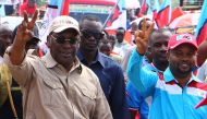 Freeman Mbowe (L), Chairman Tanzania's main opposition party Chadema, flashes a victory sign during party's first political rally after an imposed ban in 2016 was lifted, at Furahisha Grounds in Mwanza, on January 21, 2023. (Photo by MICHAEL JAMSON / AFP)
