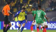 Nassr's Cristiano Ronaldo (second left) fights for the ball with Ettifaq's Saudi defender Saeed al-Mowalad the Saudi Pro League football match between Al-Nassr and Al-Ettifaq at the King Fahd Stadium in the Saudi capital Riyadh on January 22, 2023. (Photo by Fayez NURELDINE / AFP)