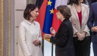 French Foreign and European Affairs Minister Catherine Colonna (right) speaks with German Federal Minister for Foreign Affairs Anna lena Baerbock as they arrive for a group picture prior to a cabinet meeting, as part of the celebration of the 60th anniversary of the signing of the Elysee Treaty, to seal reconciliation between France and West Germany, 18 years after the Second World War at the presidential Elysee Palace in Paris on January 22, 2023.  (Photo by Christophe PETIT TESSON / POOL / AFP)