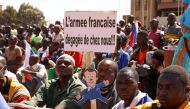 FILE PHOTO: People hold a sign as they gather to show their support to burkina Faso's new military leader Ibrahim Traore and demand the departure of the French ambassador at the Place de la Nation in Ouagadougou, burkina Faso January 20, 2023. The sign reads : 