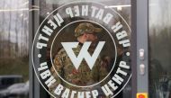 A man wearing a camouflage uniform walks out of PMC Wagner Centre, which is a project implemented by the businessman and founder of the Wagner private military group Yevgeny Prigozhin, during the official opening of the office block in Saint Petersburg, Russia, November 4, 2022. (REUTERS/Igor Russak)