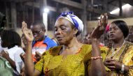 A faithful of the parish of St Charles prays as she attends the morning mass officiated by Abbey Victor Ntambwe, during which he sensitizes people to participate in the electoral process, in Kinshasa, Democratic Republic of Congo, on January 22, 2023. File Photo / Reuters