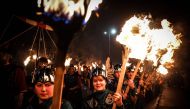 Young participants parade through the streets in Lerwick, Shetland Islands on January 31, 2023 as they take part in the Junior Up Helly Aa fire festival. (Photo by Andy Buchanan / AFP)