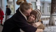 Mother Halyna, 24, hugs her daughter Arina, 6, after her evacuation from front line city of Bakhmut. Reuters/Oleksandr Ratushniak