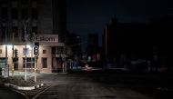 An illuminated signboard on display outside the Eskom Regional Office in Braamfontein, Johannesburg during load-shedding (rolling blackout) on 31 January, 2023. (AFP)