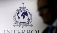 A man passes an Interpol logo during the handing over ceremony of the new premises for Interpol's Global Complex for Innovation, a research and development facility, in Singapore on September 30, 2014. File photo / Reuters