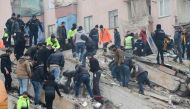 People search for survivors through the rubble in Diyarbakir, on February 6, 2023, after a 7.8-magnitude earthquake struck the country's south-east. Photo by ILYAS AKENGIN / AFP