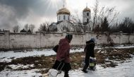 Orthodox Christians leave after the Sunday prayer at the Church of All Saints as sounds and vibrations of shelling continue in Bakhmut on February 5, 2023, amid the Russian invasion of Ukraine. (Photo by YASUYOSHI CHIBA / AFP)