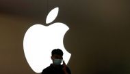 A man talks on a phone in front of an Apple logo outside its store in Shanghai, China, November 7, 2022. (REUTERS/Aly Song)