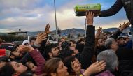 Earthquake survivors gather to collect supplies at a diaper distribution in Hatay on February 7, 2023, a day after a 7,8-magnitude earthquake struck Turkey's southeast. (Photo by BULENT KILIC / AFP)