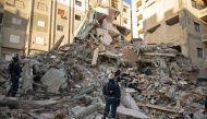 Russian rescue personnel search for survivors and victims under the rubble of a collapsed building in the town of Jableh in Syria's northwestern province of Latakia. (Photo by AFP)