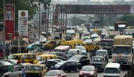 Drivers wait in line to buy fuel at and next to a filling station, causing traffic gridlock on Lagos' Ibadan expressway, in Lagos on January 30, 2023. Nigerian drivers spend hours in traffic gridlocks less than a month prior to the presidential election [Pius Utomi Ekpei/AFP]
