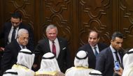 Palestinian President Mahmud Abbas (second left), Jordan's King Abdullah II (center), and Egyptian President Abdel Fattah al-Sisi (second right) talk to delegates during the Arab League's 