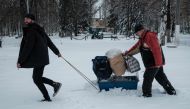 Residents put their belongings on top of a cage containing a rabit as they evacuate Chasiv Yar on February 14, 2023, amid the Russian invasion of Ukraine. (Photo by YASUYOSHI CHIBA / AFP)
