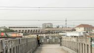 A woman looks over a bridge in Lagos on February 18, 2023, ahead of the Nigerian presidential election scheduled for February 25, 2023. (Photo by Patrick Meinhardt / AFP)