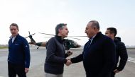 US Secretary of State Antony Blinken (center) shakes hands with Turkish Foreign Minister Mevlut Cavusoglu after a helicopter tour of earthquake stricken areas on February 19, 2023, during an official visit after a 7,8-magnitude earthquake struck Turkey's south-east.  (Photo by CLODAGH KILCOYNE / POOL / AFP)
