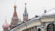 Pigeons fly above the Gostiny Dvor conference centre, the venue for tomorrow's Russian President Vladimir Putin's annual state of the nation address, with the Kremlin's Spasskaya tower and Saint Basil's cathedral on the background, in central Moscow on February 20, 2023. (Photo by Kirill KUDRYAVTSEV / AFP)

