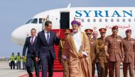 A handout picture released by the official Syrian Arab News Agency (SANA) shows President Bashar al-Assad (left) being welcomed by Oman's Sultan Haitham bin Tariq al-Said in Muscat on February 20, 2023. (AFP) 