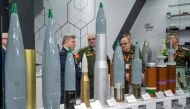 Belarusian military officers view heavy rounds on display at the Russian pavilion during the International Defence Exhibtion (IDEX) at the Abu Dhabi International Exhibition Centre on February 20, 2023. (Photo by Ryan LIM / AFP)