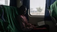 A passenger reads a book on the last train for Kaduna at the Idu Railway Station in Abuja on February 24, 2023, ahead of the Nigerian presidential election scheduled for February 25, 2023. (Photo by Michele Spatari / AFP)