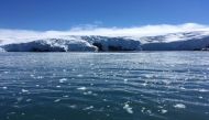 In this file photo taken on February 01, 2018, blocks of ice drift on the water off the coast of Collins glacier on King George Island, Antarctica. (Photo by Mathilde Bellenger / AFP)