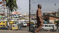 A man walks past a taxi stop in Lagos on February 28, 2023. - Nigerians are waiting for the results of their Presidential elections that where held on February 25, 2023. (Photo by JOHN WESSELS / AFP)