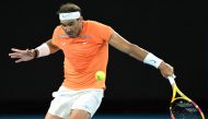 In this file photograph taken on January 18, 2023, Spain's Rafael Nadal hits a return to Mackenzie McDonald of the US during their men's singles match on day three of the Australian Open tennis tournament in Melbourne. (Photo by MANAN VATSYAYANA / AFP) 