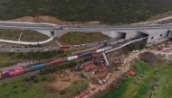 This aerial drone photograph taken on March 1, 2023, shows emergency crews examining the wreckage after a train accident in the Tempi Valley near Larissa, Greece. (AFP)