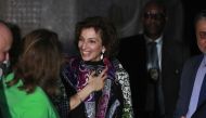 UNESCO chief Audrey Azoulay smiles as she is gifted a traditional dress during a visit to the national museum in Baghdad on March 6, 2023 as part of a three-day visit to Iraq where many priceless cultural treasures have been damaged or destroyed during decades of conflict. (Photo by AHMAD AL-RUBAYE / AFP)