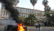 Lebanese demonstrators block a road with burning tyres in front of the Electricite Du Liban company building in the southern city of Sidon, as the country struggles with a deep economic crisis. File photo / AFP 