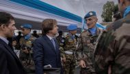 Nicolas de Rivière (third left), Permanent Representative of France to the United Nations, United Nations Organization Stabilization Mission in the Democratic Republic of the Congo (MONUSCO), speaks with peacekeepers during a ceremony in honour of peacekeepers killed in the line of duty since the mission began, in Goma on March 11, 2023. (Photo by Guerchom Ndebo / AFP)