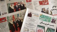 Newspapers in Tehran feature on their front page news about the China-brokered deal between Iran and Saudi Arabia to restore ties, signed in Beijing the previous day, on March 11, 2023. (Photo by Atta Kenare / AFP)