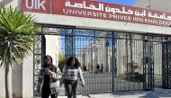 African students walk at the campus of university Ibn Khaldoun, on March 13, 2023 in Tunis. - Thousands of sub-Saharan African students in Tunisia are seeking safety assurances from authorities in the aftermath of a spate of racist attacks, which followed comments by President Kais Saied about illegal migration. (Photo by FETHI BELAID / AFP)