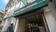 A Sri Lankan man walks past currency exchange shop in Colombo on March 20, 2023. - Cash-strapped Sri Lanka is seeking a 10-year moratorium on its foreign debt, President Ranil Wickremesinghe's office said on March 20 on the eve of a desperately needed $2.9 billion IMF bailout. (Photo by Ishara S. KODIKARA / AFP)
