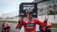 First-placed Ducati Italian rider Francesco Bagnaia poses for pictures after the sprint race of the MotoGP Portuguese Grand Prix at the Algarve International Circuit in Portimao, on March 25, 2023. (Photo by PATRICIA DE MELO MOREIRA / AFP)