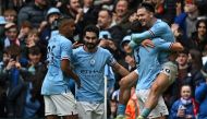 Manchester City's English midfielder Jack Grealish (R) celebrates with teammates after scoring their fourth goal during the English Premier League football match between Manchester City and Liverpool at the Etihad Stadium in Manchester, north west England, on April 1, 2023. (Photo by Paul ELLIS / AFP)