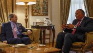 Egyptian Foreign Minister Sameh Shoukry (right) meets with his Syrian counterpart Faisal Mekdad at the ministry headquarters in Cairo, on April 1, 2023. (Photo by Khaled DESOUKI / AFP)