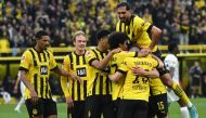 :Dortmund's German defender Mats Hummels (R - Hidden) celebrates scoring his team's third goal with his team mates during the German first division Bundesliga football match between BVB Borussia Dortmund and Eintracht Frankfurt in Dortmund, western Germany, on April 22, 2023. (Photo by INA FASSBENDER / AFP) 
