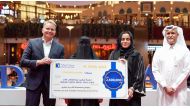 The winner of the grand prize with Doha Bank officials.