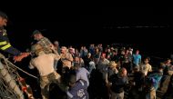 Saudi naval and special forces hoist evacuees aboard a vessel during a rescue operation from Port Sudan to Jeddah, on April 30, 2023. (Photo by Fayez Nureldine / AFP)
