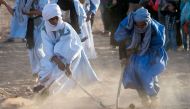 Locals play hockey during the 15th International Nomad Festival in Mhamid el-Ghizlane in Morocco's southern Sahara desert on March 24, 2018. (Photo by Fadel Senna / AFP)