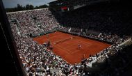 Spectators watch an exhibition match between Serbia's Novak Djokovic and Russia's Karen Khachanov on the Court Suzanne-Lenglen ahead of the Roland-Garros Open tennis tournament in Paris on May 27, 2023. Photo by Anne-Christine POUJOULAT / AFP