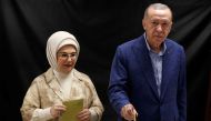 Turkey's President and presidential candidate of AK Party Recep Tayyip Erdogan (R), flanked by his wife Emine Erdogan (L), casts his ballot on the day of the Presidential runoff vote in a school in Istanbul on May 28, 2023. Photo by MURAD SEZER / POOL / AFP