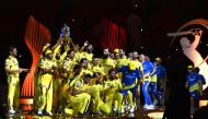 Chennai Super Kings' players celebrate with the trophy after their victory against Gujarat Titans in the Indian Premier League (IPL) Twenty20 final cricket match at the Narendra Modi Stadium in Ahmedabad on May 30, 2023. (Photo by Sajjad Hussain / AFP)